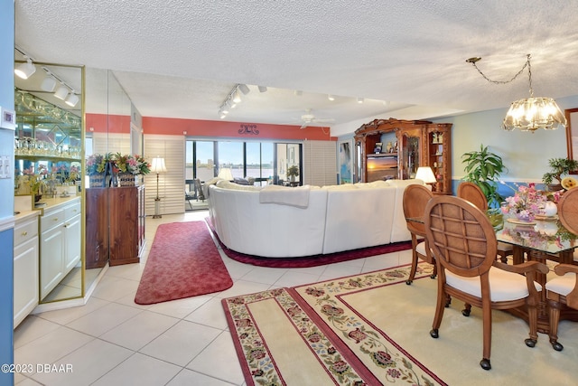 731 Marina Point Dr Unit 7310, Daytona Beach, FL 32114 - living room featuring track lighting, a textured ceiling, light tile patterned flooring, a chandelier, and ceiling fan