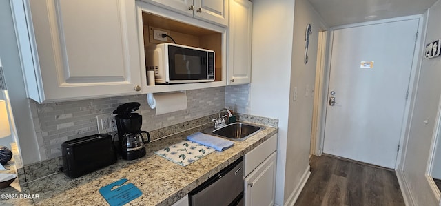 kitchen featuring sink, white cabinetry, and tasteful backsplash