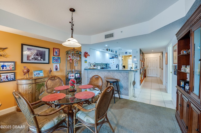 dining space with light tile patterned flooring and a textured ceiling