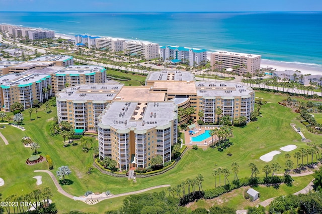 drone / aerial view featuring a view of the beach and a water view