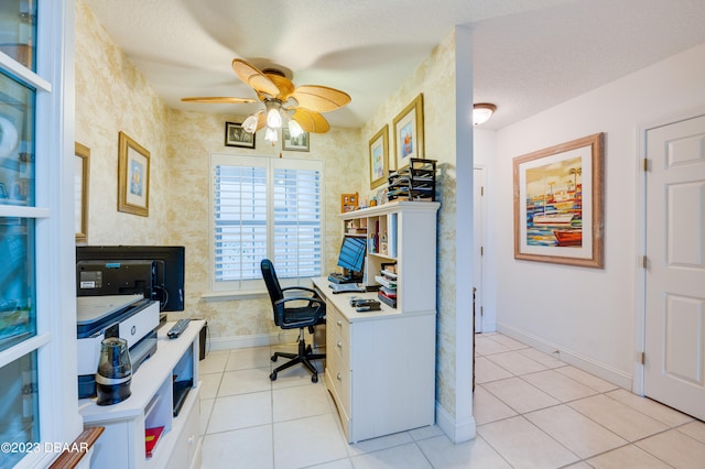 office area with a textured ceiling, light tile patterned floors, and ceiling fan