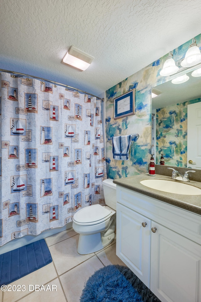 bathroom featuring toilet, tile patterned flooring, a textured ceiling, vanity, and walk in shower