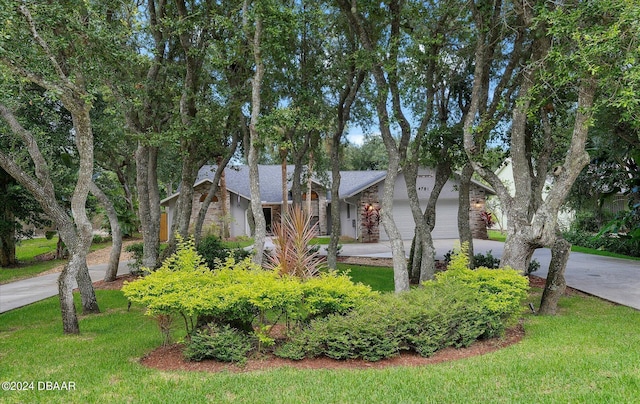 4791 S Peninsula Dr, Ponce Inlet, FL 32127 - view of front of property featuring driveway, a front lawn, and a garage