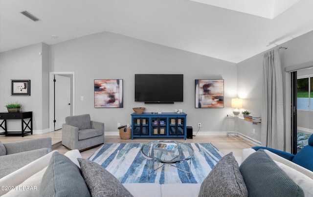 4791 S Peninsula Dr, Ponce Inlet, FL 32127 - living room with baseboards, vaulted ceiling, wood finished floors, and visible vents
