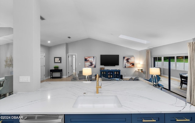 4791 S Peninsula Dr, Ponce Inlet, FL 32127 - living room featuring baseboards, lofted ceiling with skylight, wood finished floors, and visible vents