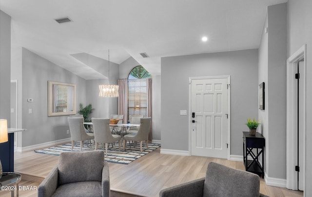 4791 S Peninsula Dr, Ponce Inlet, FL 32127 - living room featuring an inviting chandelier, light wood-style floors, and visible vents