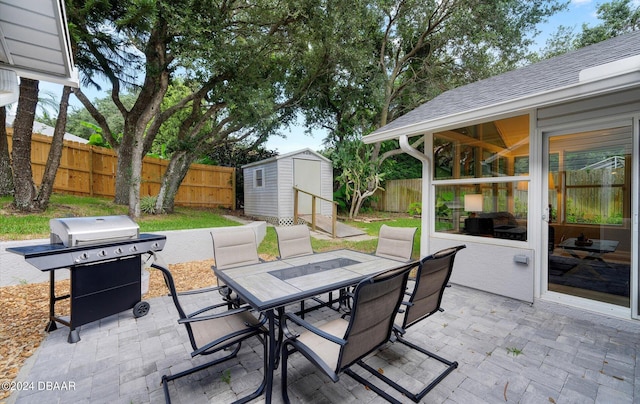 4791 S Peninsula Dr, Ponce Inlet, FL 32127 - view of patio with a storage unit, a fenced backyard, an outbuilding, and outdoor dining space
