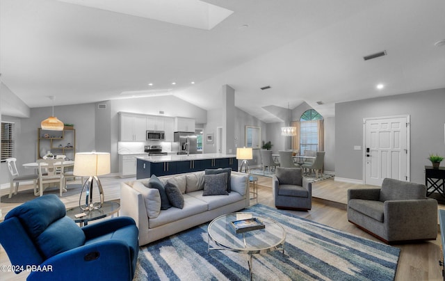 4791 S Peninsula Dr, Ponce Inlet, FL 32127 - living area with recessed lighting, baseboards, light wood finished floors, and lofted ceiling with skylight