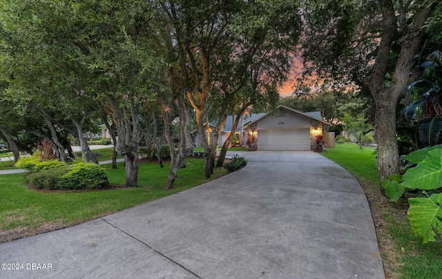 4791 S Peninsula Dr, Ponce Inlet, FL 32127 - view of front facade featuring an attached garage, driveway, and a front yard