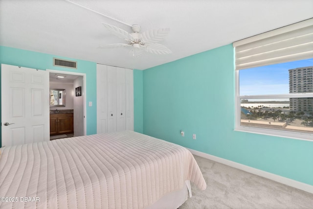 carpeted bedroom with a closet and ceiling fan