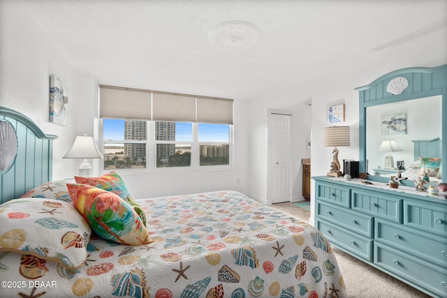 bedroom featuring light colored carpet and a closet