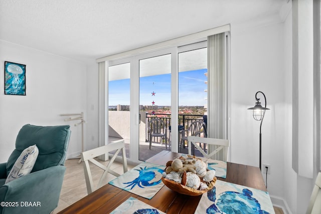 dining space featuring a wall of windows