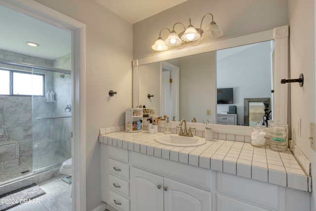 bathroom with vanity, toilet, and a shower with shower door