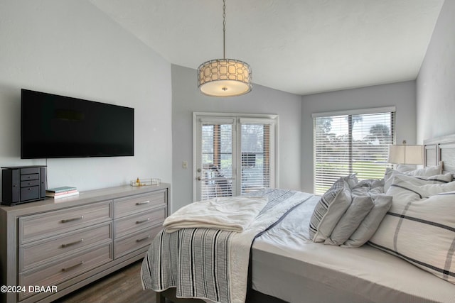 bedroom with access to outside and dark hardwood / wood-style floors