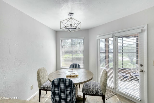 dining space with a wealth of natural light and a chandelier