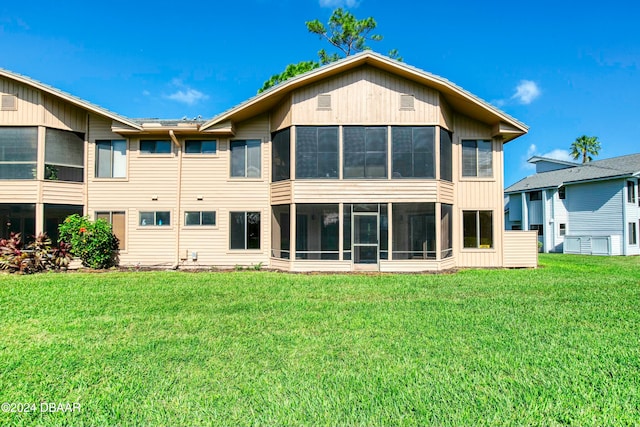 back of property featuring a lawn