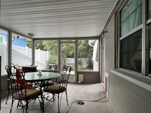 806 E 2nd Ave, New Smyrna Beach, FL 32169 - sunroom with concrete flooring and outdoor dining space