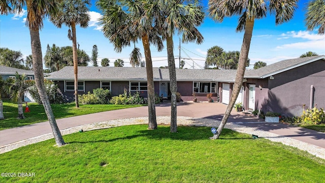 153 University Cir, Ormond Beach, FL 32176 - ranch-style home featuring driveway, an attached garage, a front lawn, and stucco siding