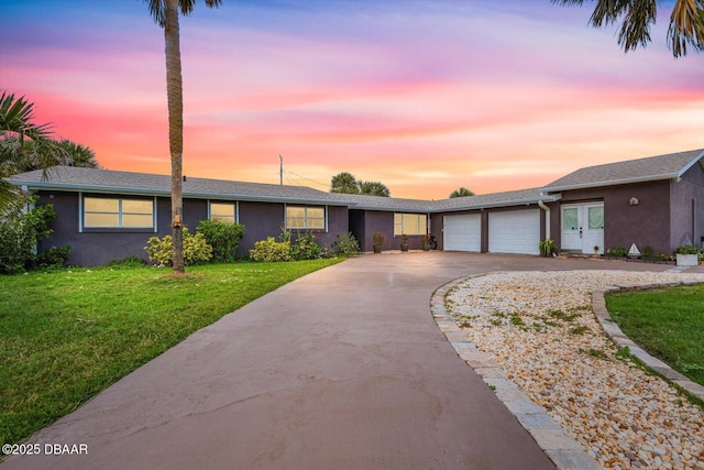 153 University Cir, Ormond Beach, FL 32176 - ranch-style home featuring driveway, a front lawn, a garage, and stucco siding