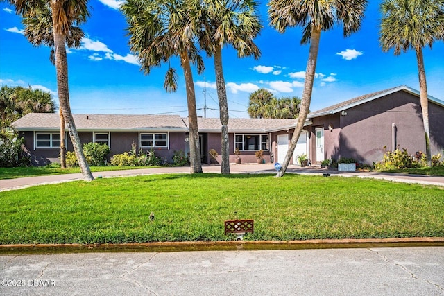 153 University Cir, Ormond Beach, FL 32176 - ranch-style house with a garage, concrete driveway, a front yard, and stucco siding