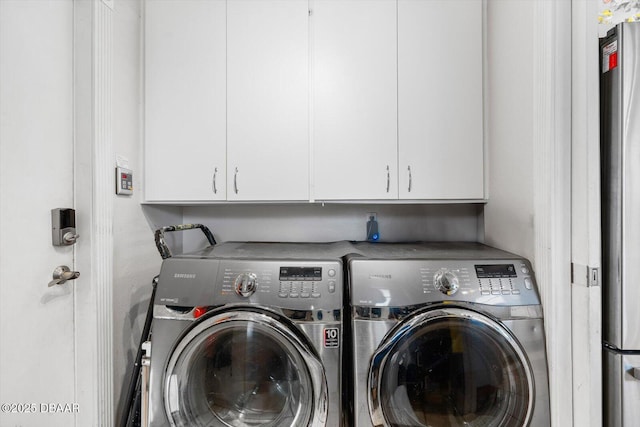 153 University Cir, Ormond Beach, FL 32176 - laundry area with cabinet space and washing machine and clothes dryer