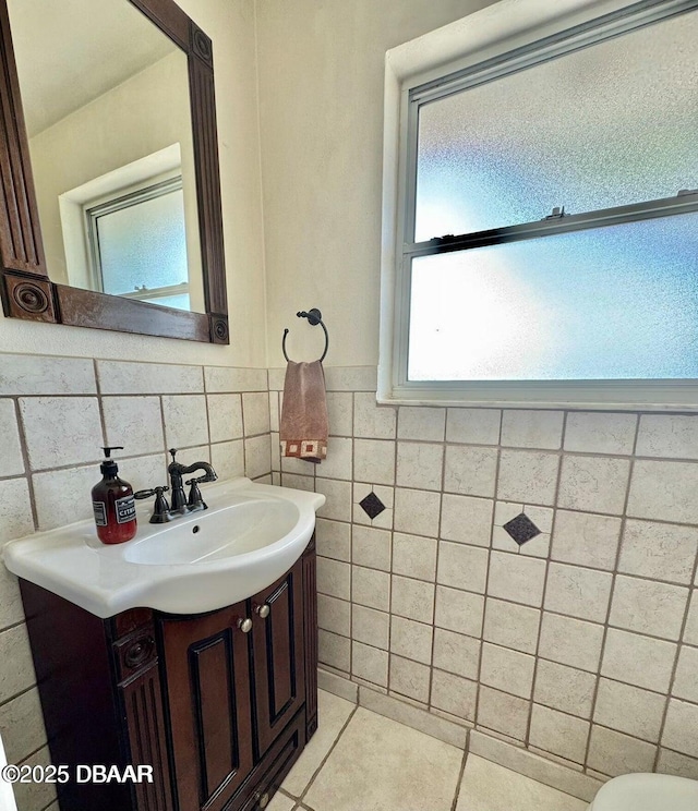 153 University Cir, Ormond Beach, FL 32176 - bathroom with vanity, tile patterned floors, wainscoting, and tile walls