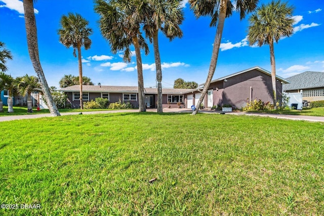 153 University Cir, Ormond Beach, FL 32176 - ranch-style house featuring a front yard, stucco siding, and driveway