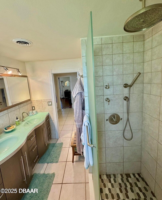 153 University Cir, Ormond Beach, FL 32176 - bathroom with double vanity, tiled shower, tile patterned floors, tile walls, and a textured ceiling