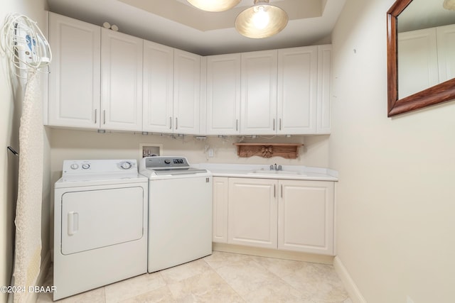 laundry room with sink, cabinets, washer and clothes dryer, and light tile patterned floors