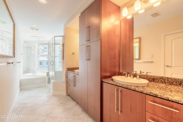 bathroom with shower with separate bathtub, vanity, and tile patterned floors