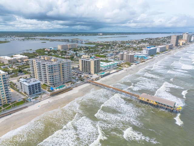 aerial view with a beach view, a water view, and a view of city