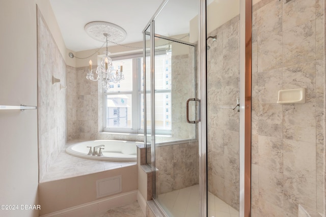 bathroom with an inviting chandelier and independent shower and bath