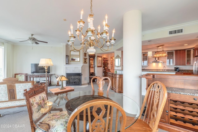 dining space featuring sink, ornamental molding, and ceiling fan