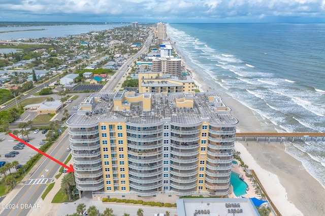 birds eye view of property featuring a beach view and a water view