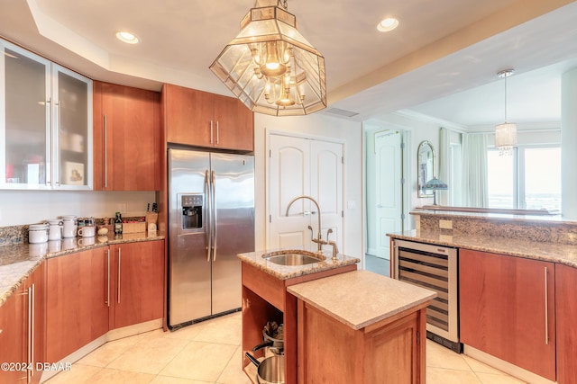 kitchen with an inviting chandelier, wine cooler, stainless steel fridge with ice dispenser, sink, and decorative light fixtures