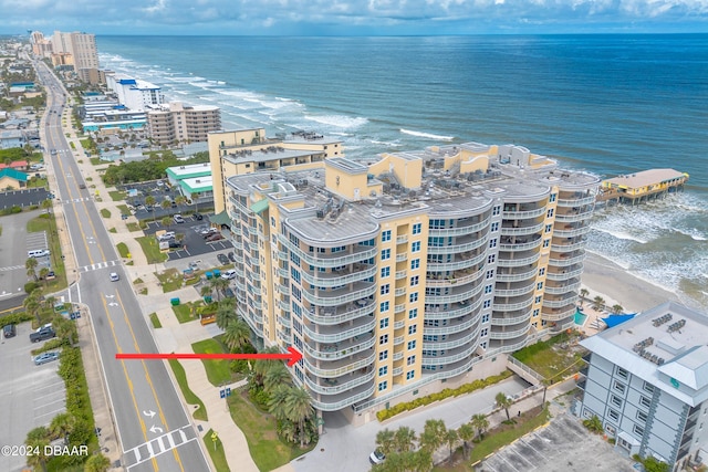 bird's eye view featuring a city view, a water view, and a beach view