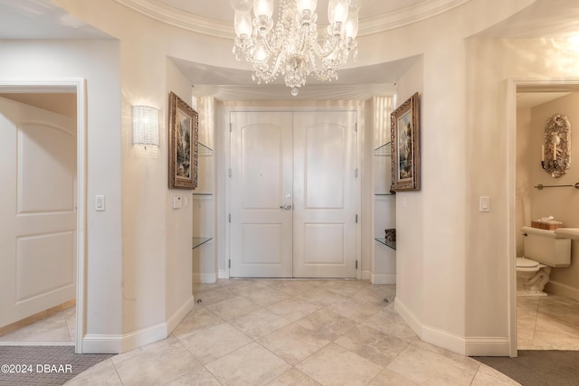 hall with an inviting chandelier, light tile patterned floors, and crown molding