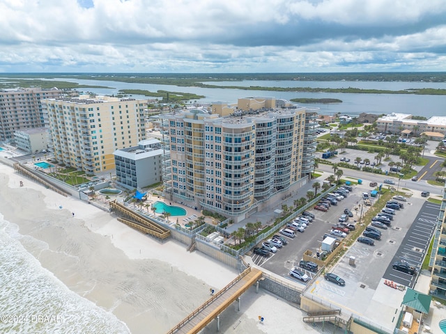 birds eye view of property with a beach view and a water view