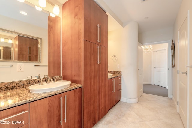 bathroom featuring a notable chandelier, tile patterned floors, and vanity