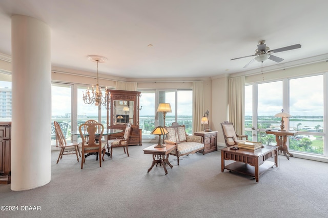 interior space with a water view, light carpet, ceiling fan with notable chandelier, and ornamental molding