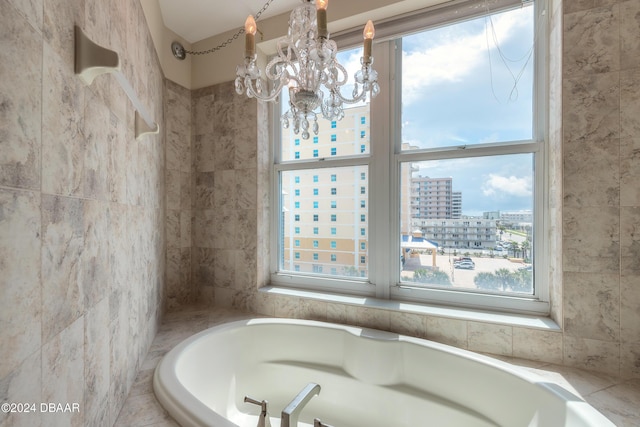 bathroom with a relaxing tiled tub and a notable chandelier