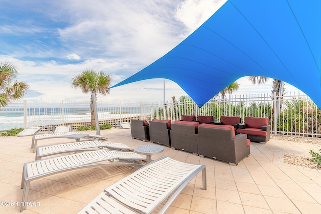 3703 S Atlantic Ave Unit 501, Daytona Beach Shores, FL 32118 - view of patio with outdoor lounge area, fence, and a water view