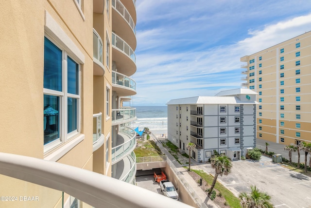 view of building exterior with a water view and a view of the beach