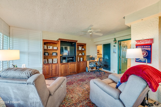 carpeted living room with ceiling fan and a textured ceiling