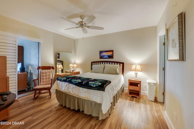 bedroom with light hardwood / wood-style floors and ceiling fan