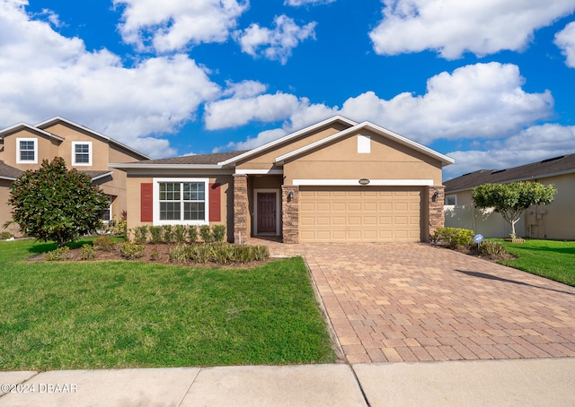 view of front facade with a garage and a front lawn