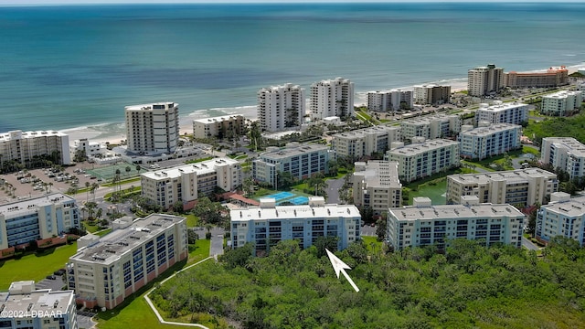 bird's eye view with a water view and a beach view