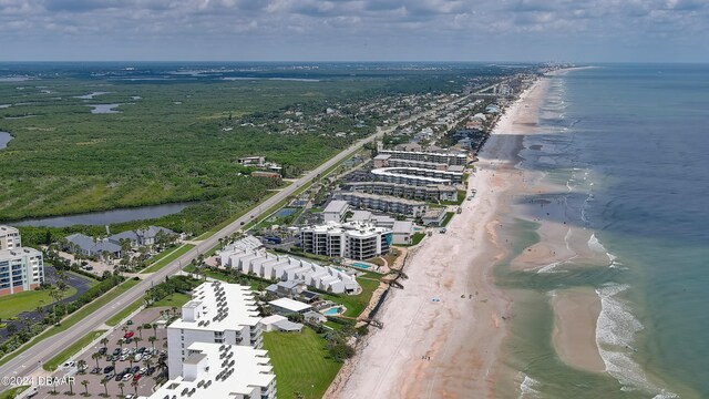 drone / aerial view featuring a beach view and a water view