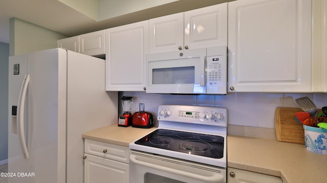 kitchen with white cabinets and white appliances