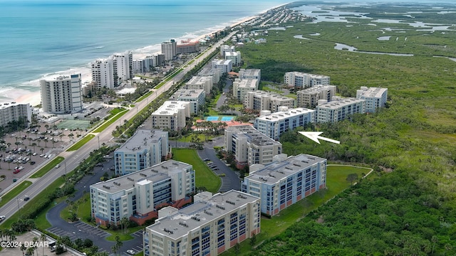 drone / aerial view featuring a beach view and a water view